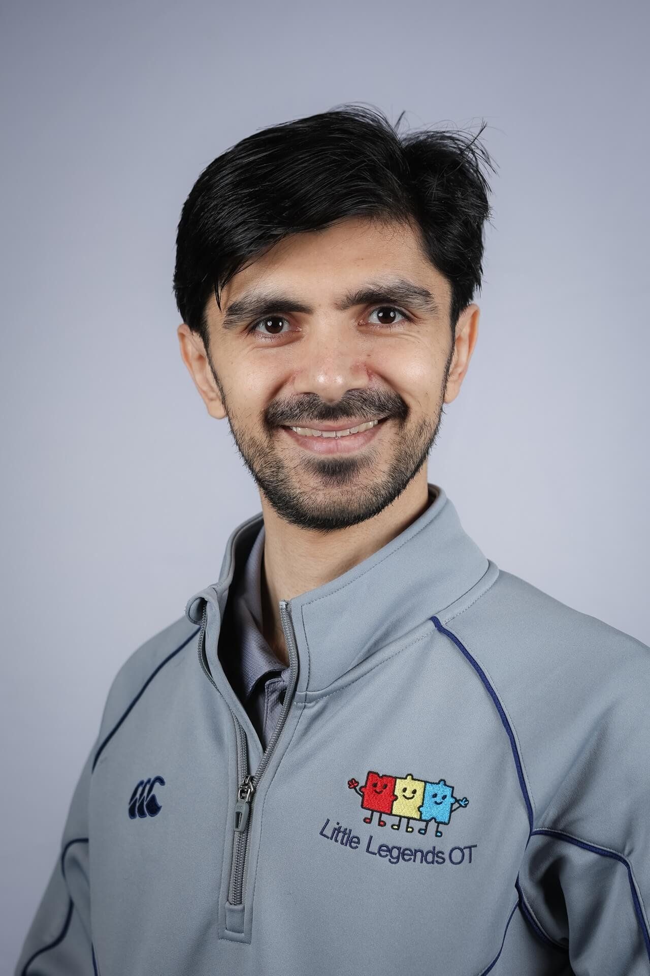 Farzad, Senior Occupational Therapist at Little Legends OT, in a grey Little Legends jacket.